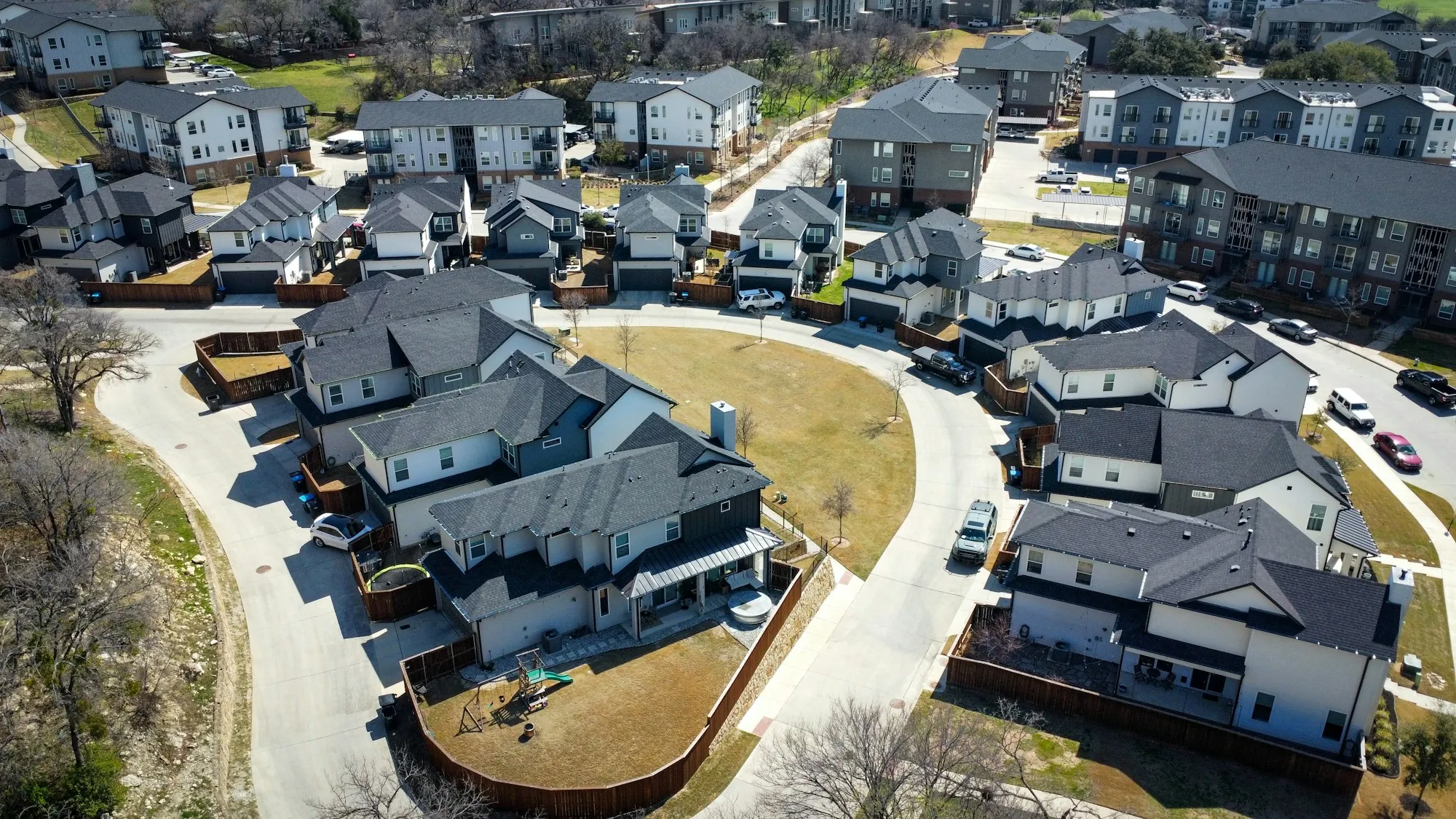Aerial view of a new subdivision of homes with dark roofs